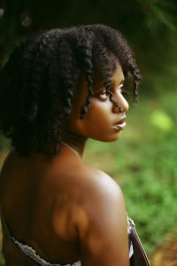 A woman with natural curls styled with leave-in conditioner.