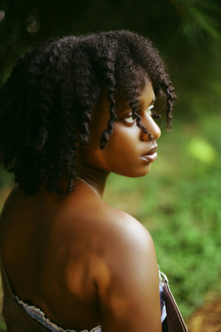 A woman with natural curls styled with leave-in conditioner.